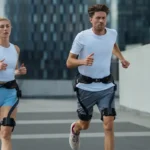 photograph shows a male and female runner wearing a Hypershell exoskeleton