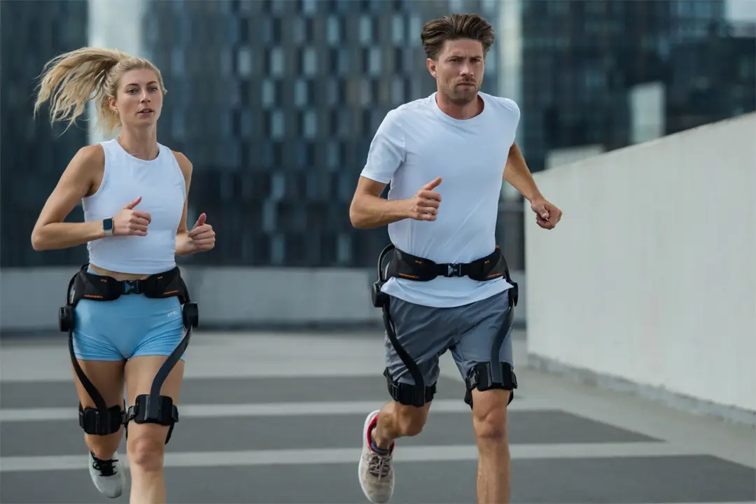 photograph shows a male and female runner wearing a Hypershell exoskeleton