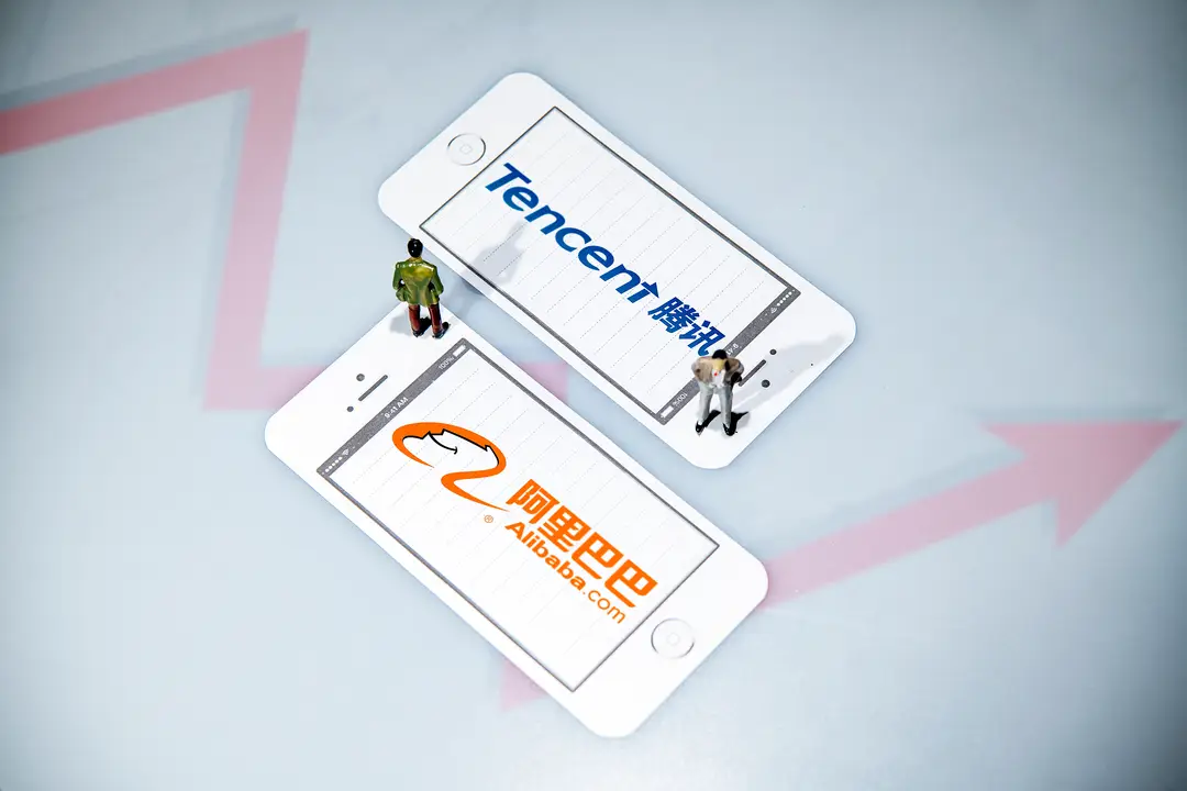 image shows two smartphones with the logos of Tencent and Alibaba in English and Chinese
