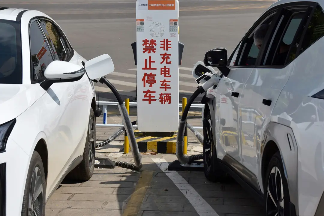 photograph of EV cars charging batteries at a charging station