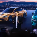 Photograph shows Xiaomi's founder and CEO Lei Jun with two of its most successful models in the background