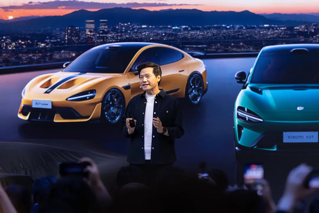 Photograph shows Xiaomi's founder and CEO Lei Jun with two of its most successful models in the background