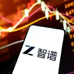 Photograph shows a smartphone with the logo of Ship with a share price graph in the background