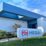 Photograph shows the Hesai name and logo with its headquarters in the background
