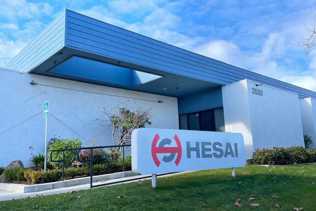 Photograph shows the Hesai name and logo with its headquarters in the background