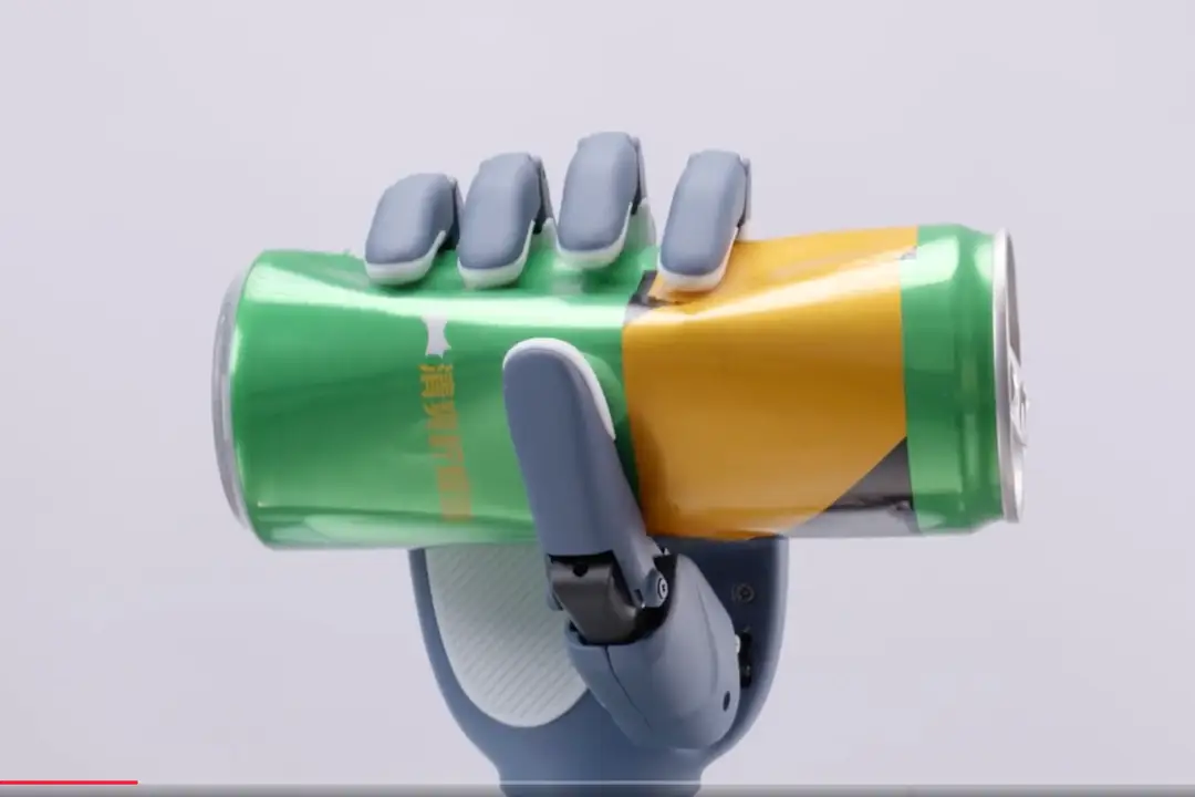 picture shows Linkerbot's O6 dexterous hand crushing a metal can