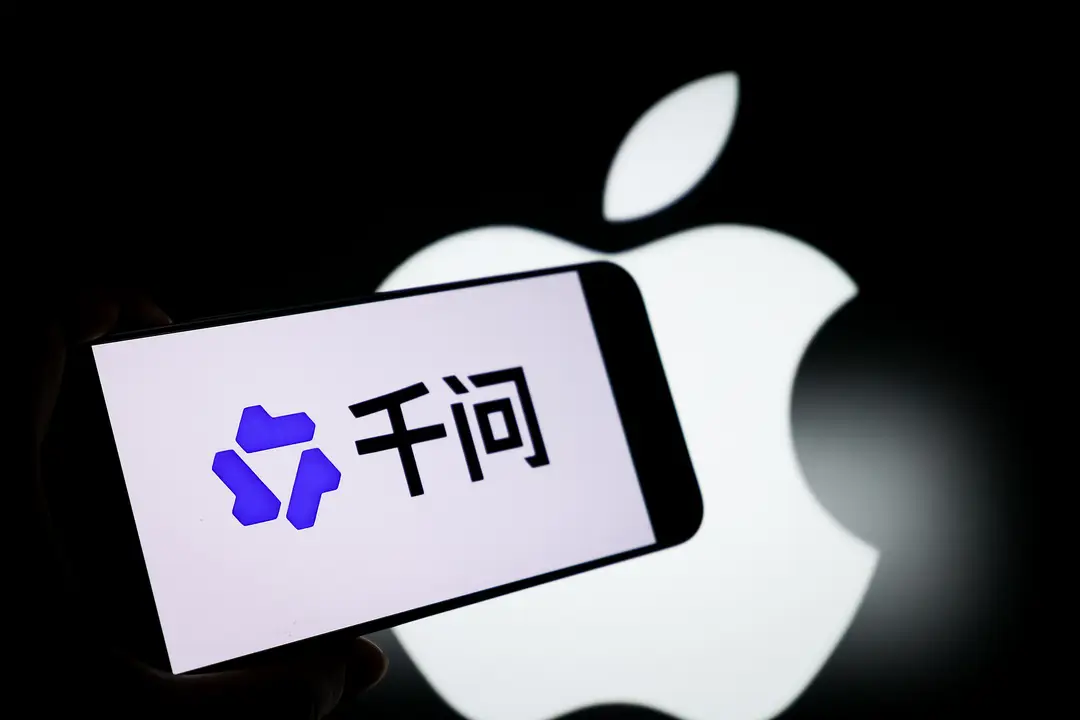 Picture shows a smartphone with the Qwen logo and the Apple logo in the background