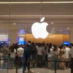 photograph shows customers queueing at the Apple Store in Shenzhen